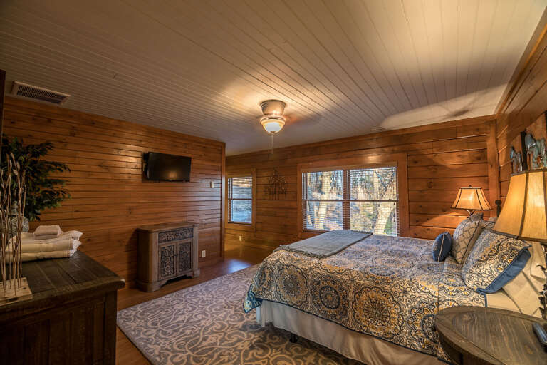 Main level bedroom with King sized bed and private bathroom