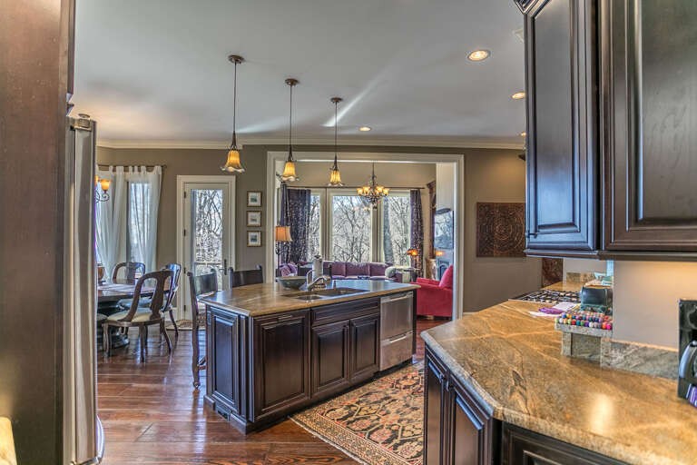 Large kitchen with stainless steel appliances including a double drawered dishwasher and gas range.