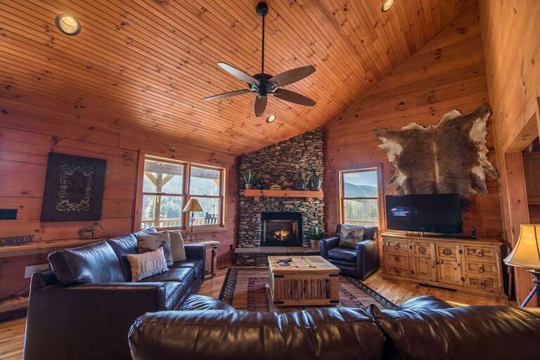 Living area with gas log fireplace, TV and mountain views