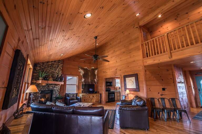 Living area with gas log fireplace, TV and mountain views