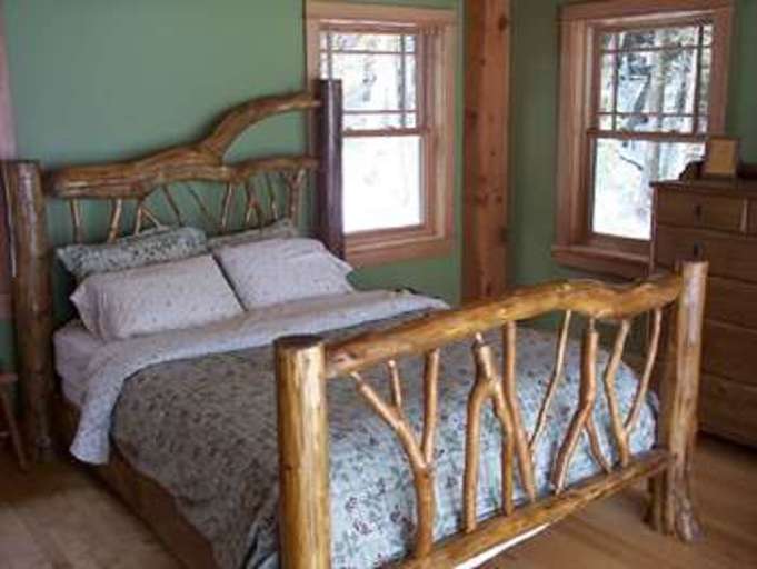 Bedroom 2 - handmade log bed, room has balcony and woodburni