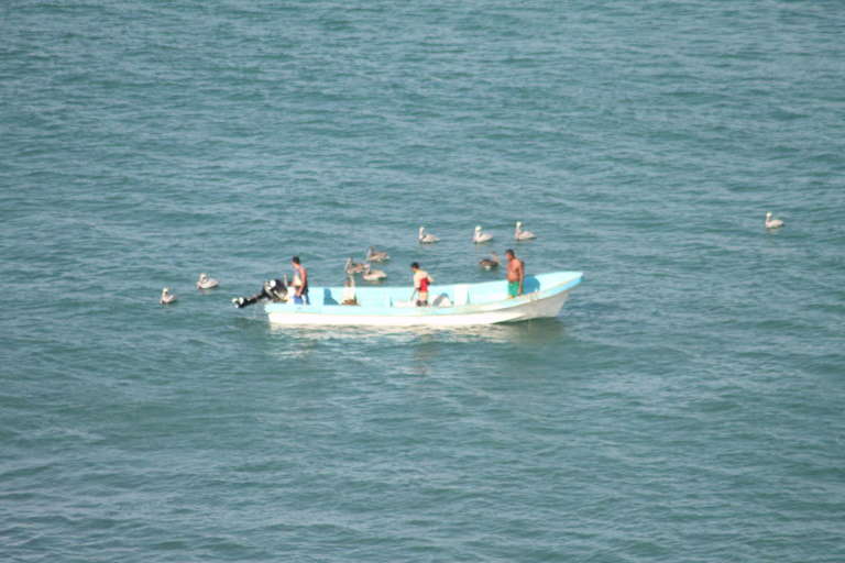 Gigante fishermen checking nets below the house