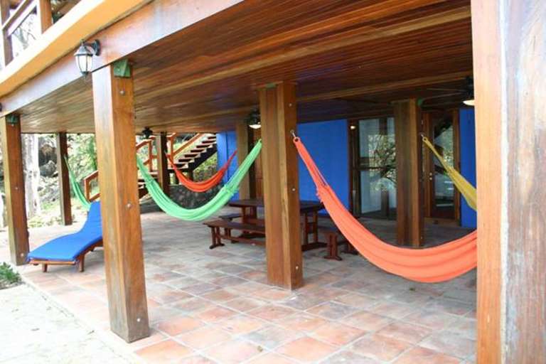 Lower level poolside deck features hammocks & lounges