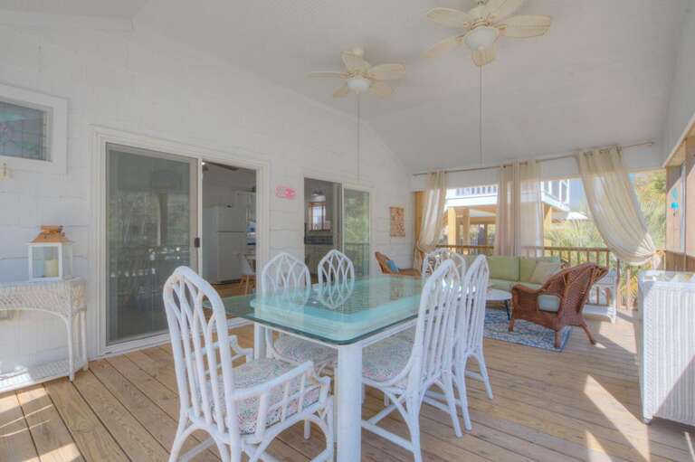 Breezy Balcony With Wicker Chairs And Glass Dining Table