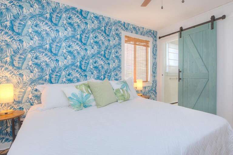 Tropical-themed Room, Leafy Wallpaper, Sliding Barn Door, Soft Bedding