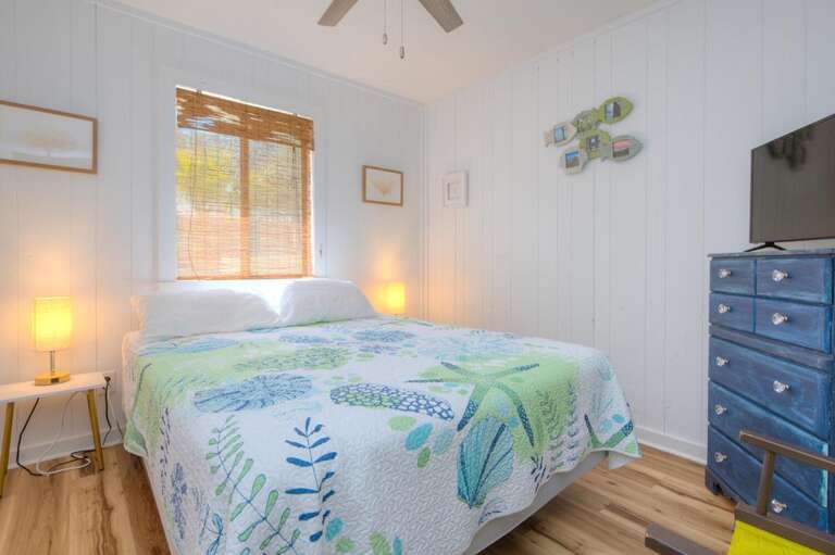 Bed, Blue Dresser, Bright Lamps, Leafy Quilt, Window Light