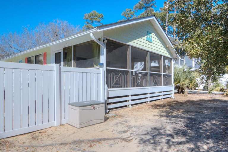 Sunny Screened Porch With White Fence