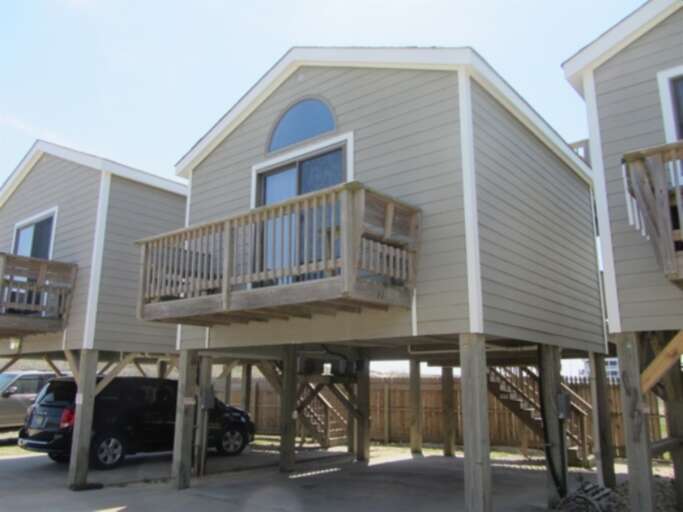 Stilt House With Balcony And Parked Car Stilt House With Balcony And Parked Car