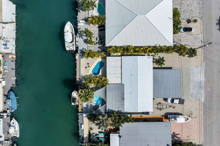 Aerial View Of Buildings Surrounded By Boats And Water