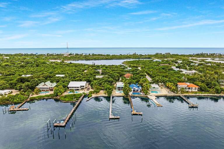 Aerial View Of Coastal Residential Area With Docks And Boats