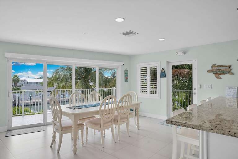 Interior Of A Room With Dining Table, Chairs, And Kitchen Counter