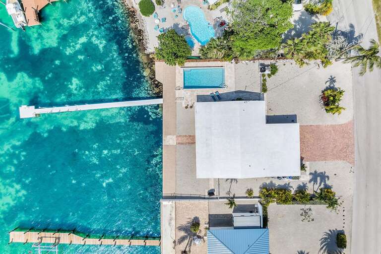 Aerial View Of Seaside Building With Pool And Pier Aerial View Of Seaside Building With Pool And Pier