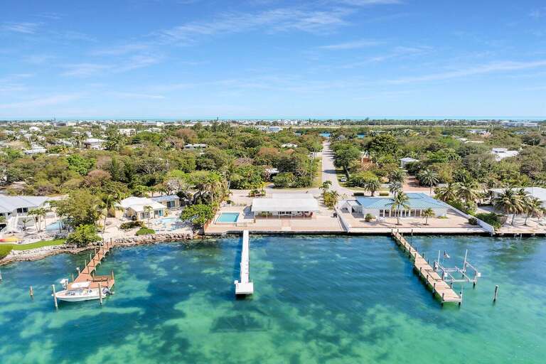 Aerial View Of A Coastal Residential Area With Piers And Boats Aerial View Of A Coastal Residential Area With Piers And Boats