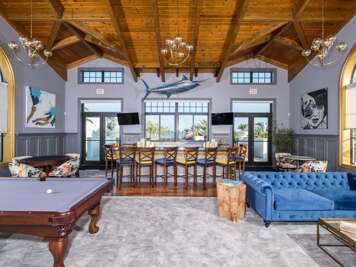 Spacious Living Area With Pool Table And Seating
