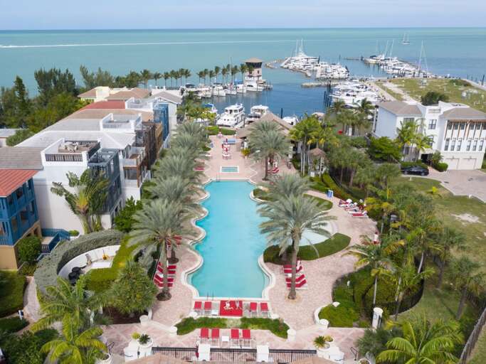 Aerial View Of A Resort With Pool And Marina