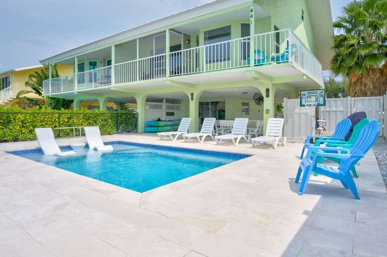 Two-story Building With Pool And Patio Chairs Two-story Building With Pool And Patio Chairs
