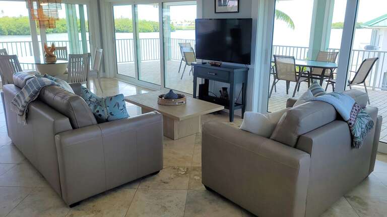 Living Room Interior With Furniture And Waterfront View