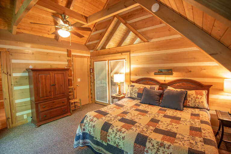 King bed in the master bedroom upstairs with vaulted ceilings...