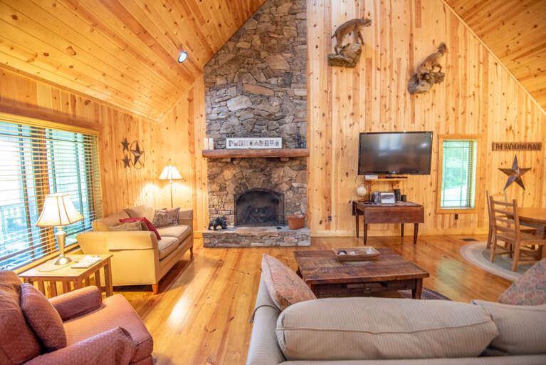 Stone fireplace, seating and BIG TV...