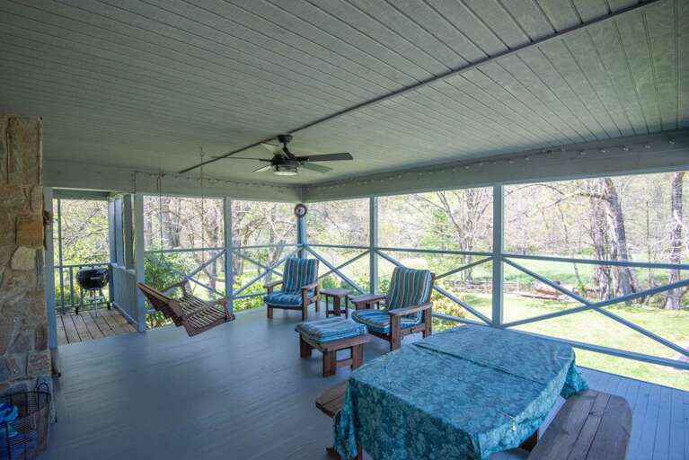 Plenty of seating in the screened in porch...