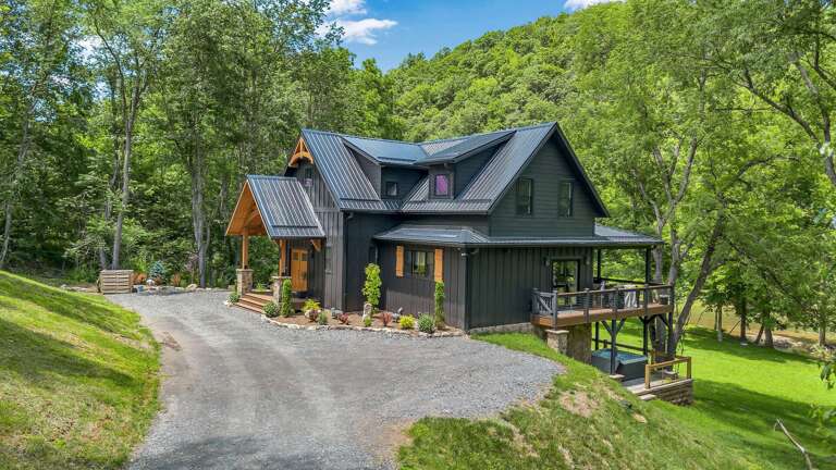 Serene Structure Surrounded By Green, Gravel Path Guiding To Gracious Gateway