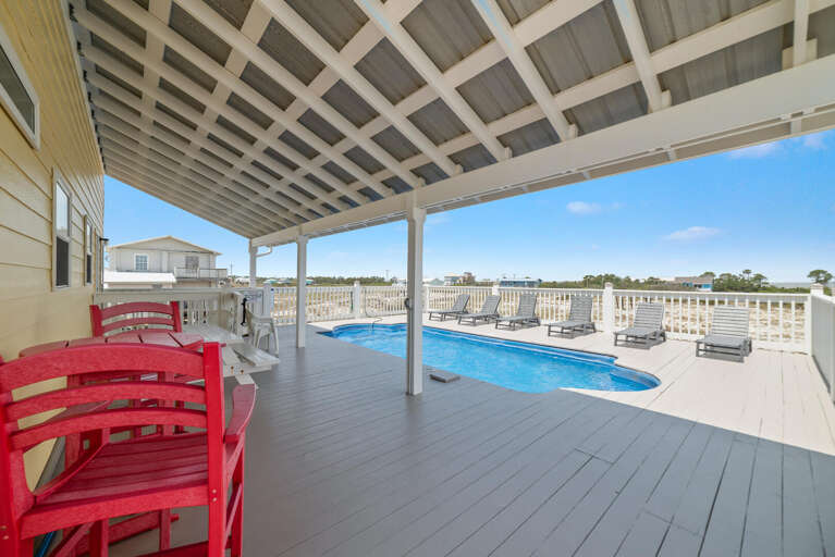 Patio Perspective With Pool, Prominent Red Chairs