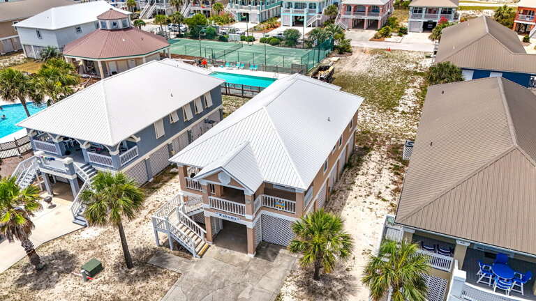 Aerial View Of Breezy Beachside Vacation Rental Buildings Nestled Near Pools