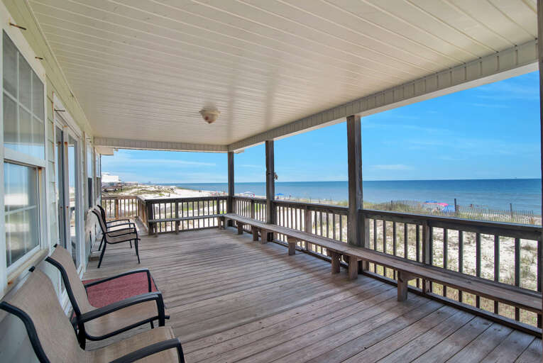 Seaside Deck With Chairs Overlooking Beach And Ocean