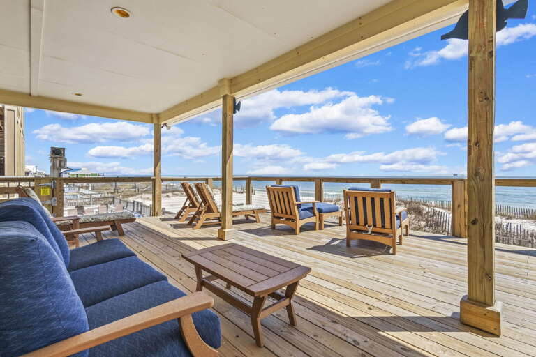 Seaside Deck With Wooden Chairs Overlooking Beach