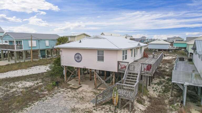 Stilted Structures Stretching Along Sandy Shores