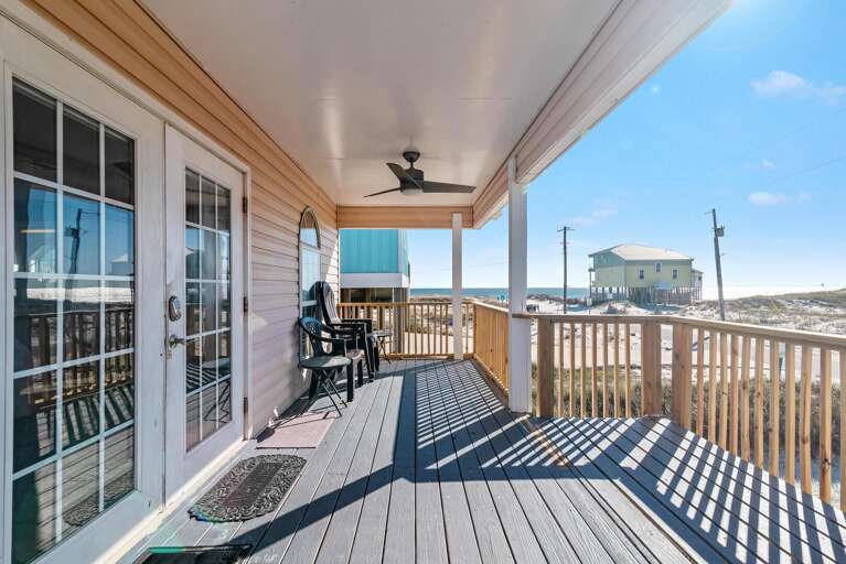 Sunlit Seaside Deck With Chairs Facing Fresh Breezes