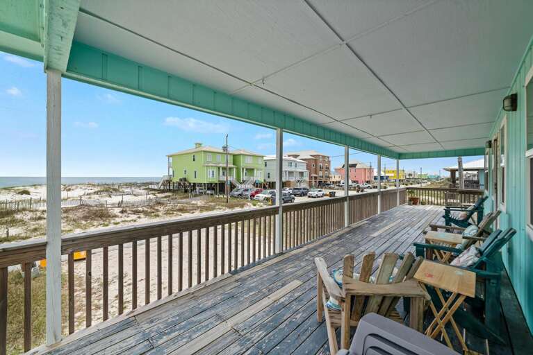 Beachside Balcony View With Chairs Overlooking Coastal Town