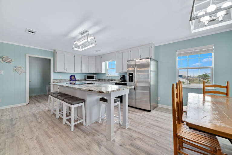 Vacation Rental Kitchen With Sleek Surfaces And Spacious Seating By Serene Sea-view Windows