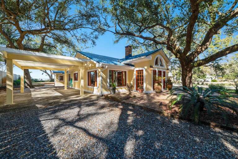 Sunny Small Structure Sheltered By Sprawling Trees