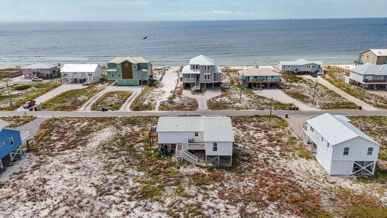 Aerial View Of Beachside Buildings Beside Serene Sea
