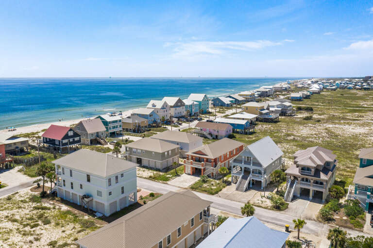 Aerial View Of Seaside Structures Scattered By Shore
