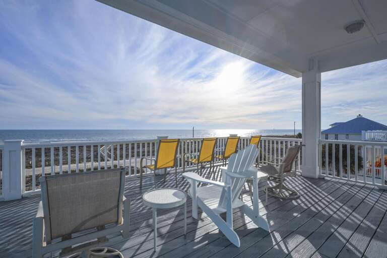Sun-splashed Seaside Space With Shaded Seating