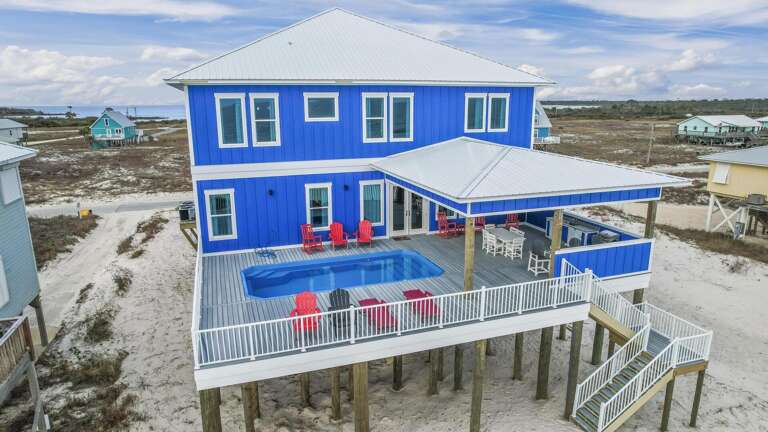 Blue Beachside Building With Balcony And Pool