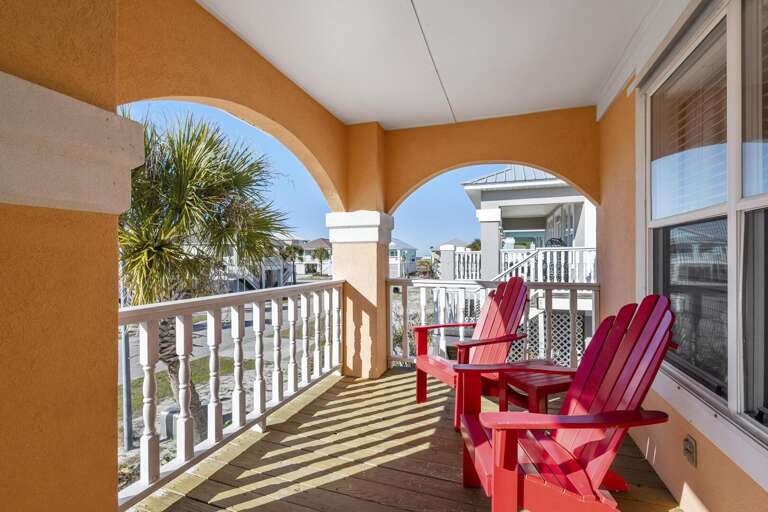 Sunny Terrace With Red Chairs, Round Arches, And Railing Shadows