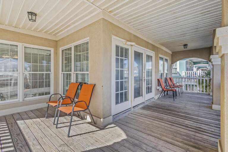Sunlit Space Showcasing Shaded Seats And Sizable Sliding Doors