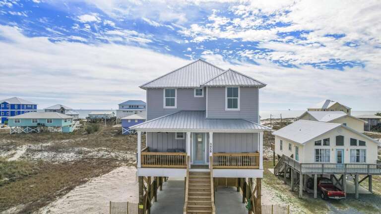 Seaside Structure Stands Surrounded By Similar Setups, Sky High