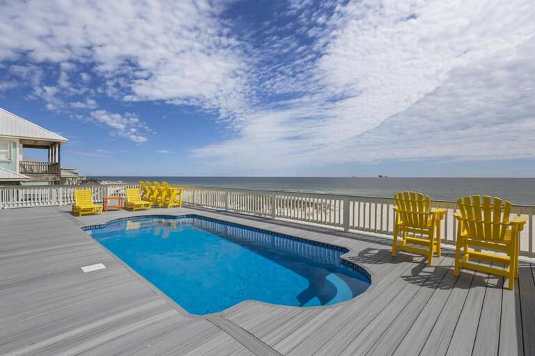 Seaside Deck With Pool And Chairs Facing The Ocean