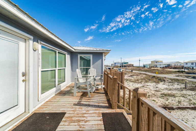 Seaside Structure With Wooden Walkway, White Chair Under Blue Sky