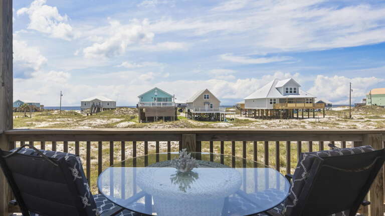 Beachfront View From Balcony, Casual Chairs Facing Clustered Cottages