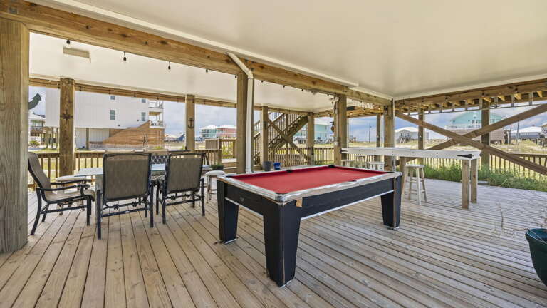 Spacious Sunlit Deck Sporting A Pool Table And Plush Patio Furniture