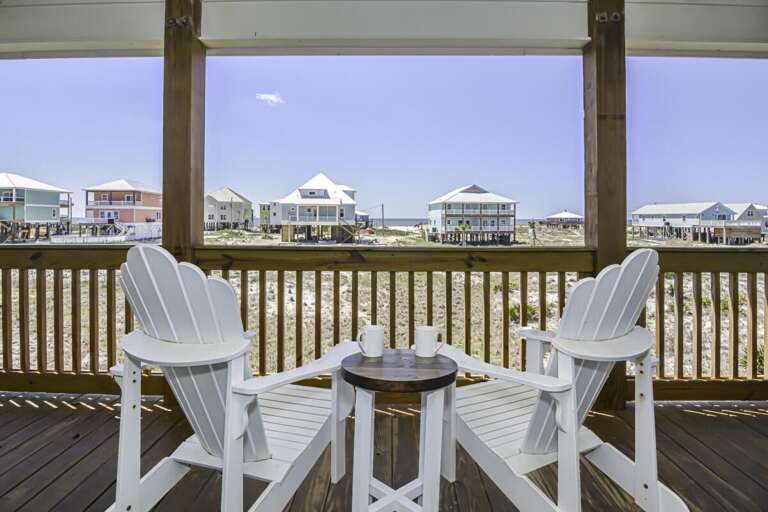 Chairs Facing Beach Houses From Breezy Boardwalk Balcony