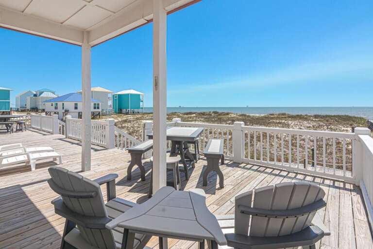 Beachside Balcony At Vacation Rental With Seating Overlooking Dunes