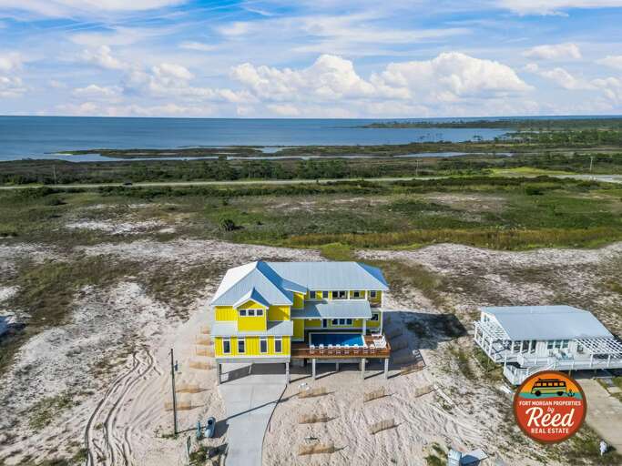 Yellow And White Buildings Beside Blue Bay