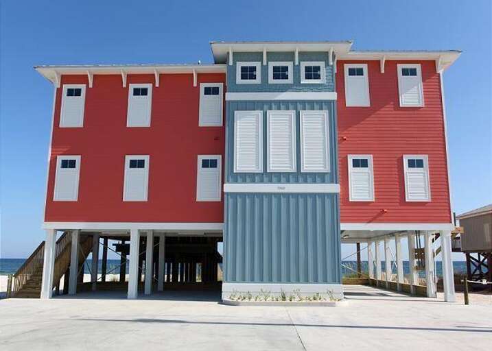 Red Rental Residence Raised On Robust Stilts By The Sea