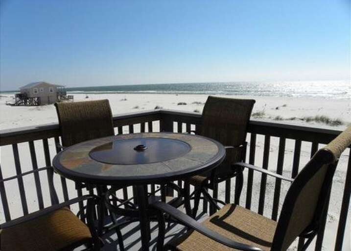 Beachfront Balcony With Table Overlooking Sandy Shore And Sea